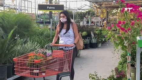 Woman-shopping-in-Home-Depot-outdoor-garden-section-wearing-face-mask