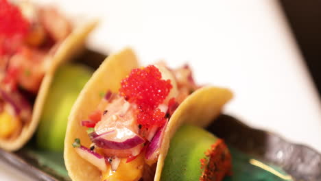 Chef-Putting-Red-Caviars-On-Top-Of-Delicious-Sushi-Tacos
