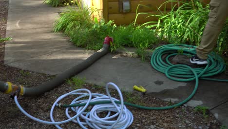 Coachmen-dumping-hoses-being-coiled-and-left-on-the-ground