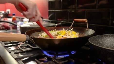 Home-cooked-Stir-Fry-being-poured-into-a-wok-and-stirred-around