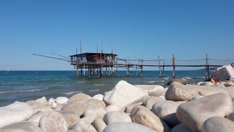 Couple-of-tourists-relax-at-trabocco-or-trabucco-beach-in-Abruzzo,-Italy