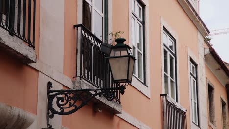 Street-Lamp-attached-to-building-in-Lisbon,-Portugal
