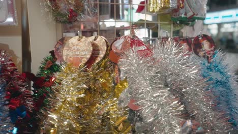 Metallic-Tinsel-Garlands-For-Christmas-Decoration-Display-On-A-Shop-In-Tokyo,-Japan