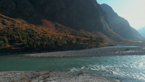 Aqua-color-glacier-water-river-stream-flowing-through-majestic-mountain-ranges-of-Himalayas