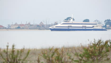 Passenger-Boat-Cruising-On-River-On-A-Foggy-Morning-From-Riverside