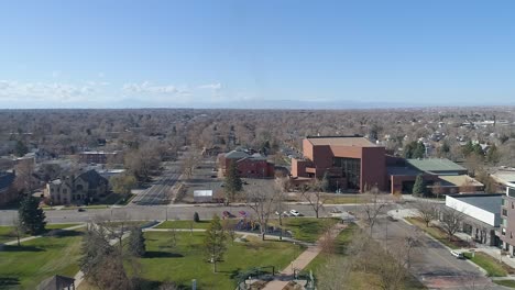 Greeley-civic-center,-concert-hall,-lincoln-park-and-the-mountains-on-an-early-morning-drone-shot