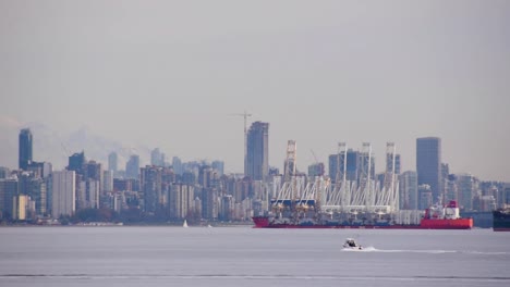 Densely-populated-skyline-of-Vancouver-from-port,-long-shot