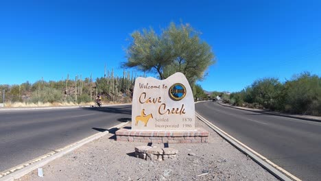 Several-bicycle-riders-peddle-out-of-the-town-of-Crave-Creek,-Arizona