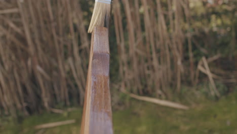 Close-up-shot-of-putting-linseed-oil-onto-a-wooden-chair-with-a-brush
