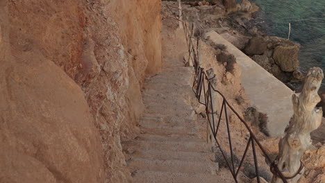 Slow-motion-of-descending-down-the-rocky-stairs-in-Ibiza