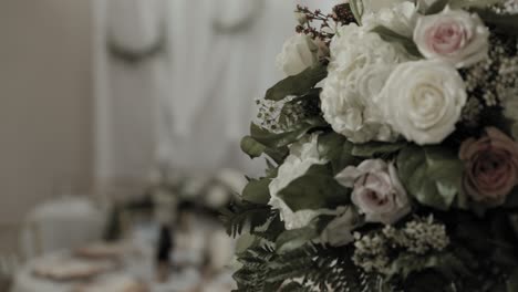 Head-table-reveal-from-behind-a-beautiful-pink-and-white-bouquet-of-roses