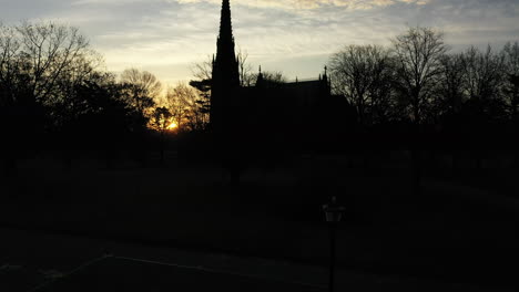 A-low-angle-shot-of-a-cathedral-with-a-tall-steeple-during-sunrise