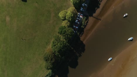 Top-down-view-over-parkland-and-boats-at-the-mouth-of-the-Exe-River-in-Devon,-UK