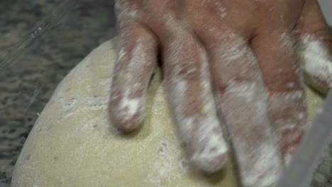 Bread-dough-is-gently-caressed-by-the-hand-of-the-baker