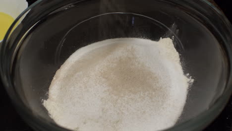 Yeast-Being-Added-On-Top-Of-Flour-In-Mixing-Bowl