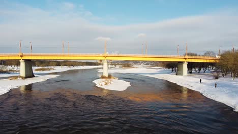 Side-low-angle-shot-of-Kaunas-Vilijampole-bridge-during-winter