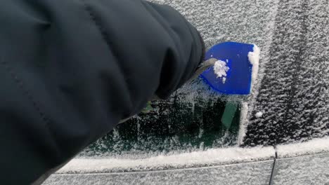 Scraping-ice-from-frozen-car-side-window