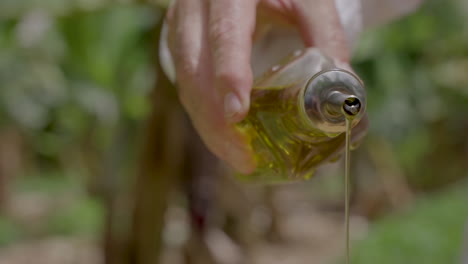 The-chef-pours-extra-virgin-olive-oil-over-the-cooking-dish-from-a-bottle