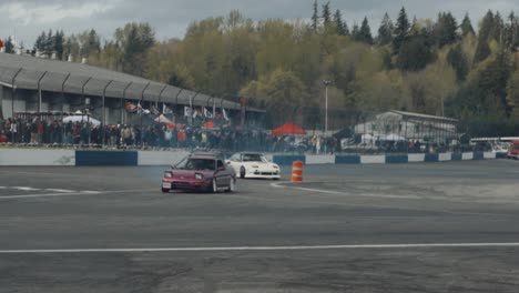 Sports-Cars-Drifting-on-a-Curvy-Racing-Circuit,-Wide-Slow-Motion-View