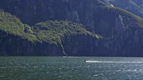 Jet-Skiing-At-Milford-Sound-On-A-Sunny-Day-At-Fiordland,-New-Zealand
