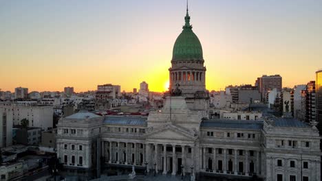 Aerial-dolly-out-of-Argentine-Congress-Palace-with-green-bronze-dome-at-golden-hour,-Buenos-Aires