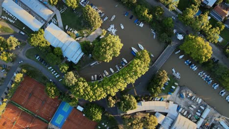 Aerial-view-of-a-nautical-club-with-some-tennis-courts-and-boats-docked