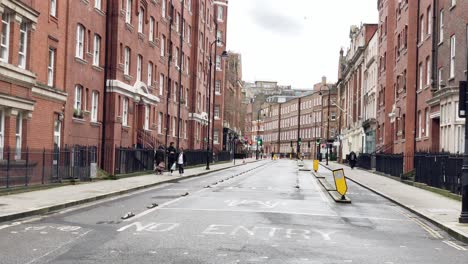 Slow-pan-of-a-typical-London-street-with-red-brick-buildings