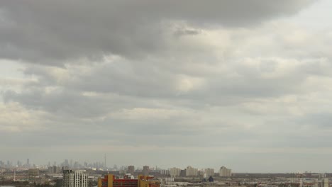 Timelapse-of-cloudy-sky-with-minimalistic-cityscape-in-Toronto,-Canada