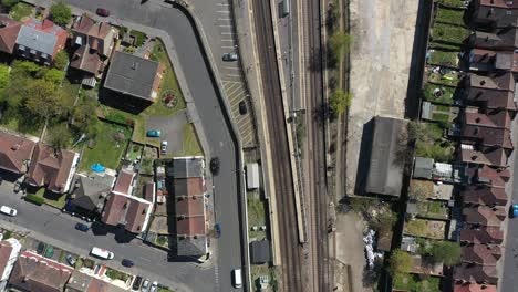 drone-shot-over-railway-passing-through-gentrified-suburban-london