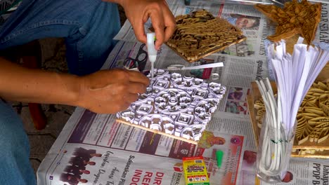 Batik-expert-making-stamp-to-manufacture-stamped-batik,-Java,-Indonesia