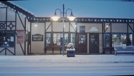 Early-morning-in-Poulsbo-Washington-with-a-rare-snowfall,-a-view-of-Verksted-Gallery-with-a-snow-plow