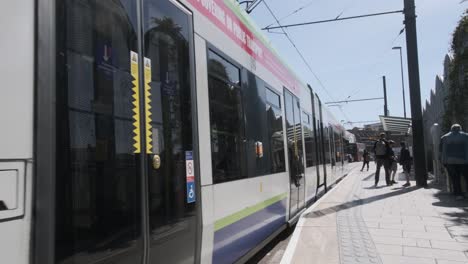 London-tram-leaving-West-Croydon-station-platform