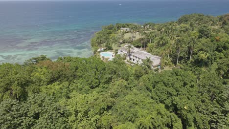 Tropical-forest-and-Caribbean-sea-by-Rio-Chico-Private-Estate,-Jamaica,-aerial