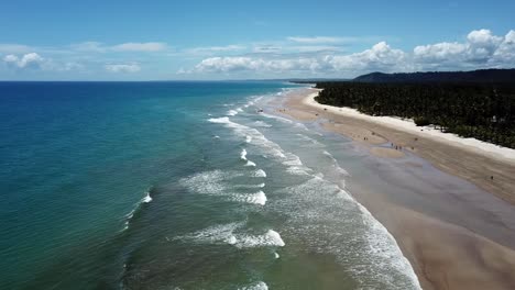 Waves-crashing-against-the-sandy-beach-in-this-tropical-paradise---aerial-view