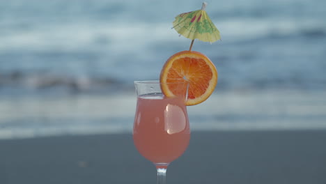 Cocktail-drink-with-orange-slice-at-the-beach