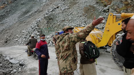 People-Rushing-To-The-Other-Side-As-Landslide-Gets-Cleared-On-Karakoram-Highway-In-Pakistan---handheld-shot