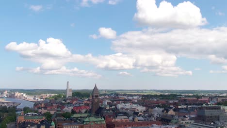 Downtown-and-church-tower-of-Norrkoping-in-aerial-tilt-down-view