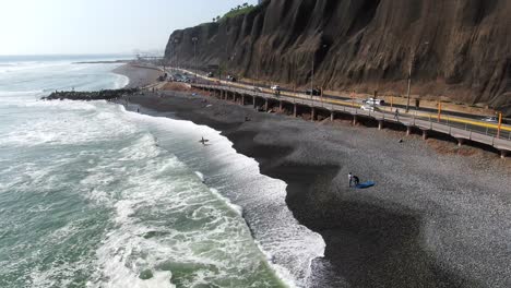 4k-daytime-aerial-fast-footage-of-the-Pacific-Ocean-hitting-its-powerful-waves-on-the-Miraflores-coast-and-the-cobblestone-beaches