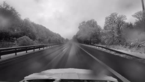 Driving-fast-at-a-motorway-with-no-other-cars-in-black-and-white-at-times-of-corona-and-the-pandemic-virus-in-black-and-white
