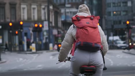 Cyclist-on-busy-London-street-surrounded-by-traffic-slow-motion