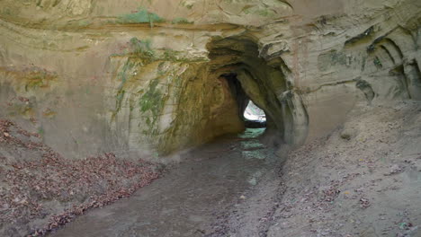 Zoom-in-shot-of-abandoned-sand-cave-hole-in-mountains-of-Switzerland,Europe---prores-footage