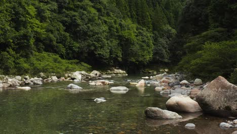 Forward-push-over-tranquil-Mountain-Stream,-Gifu-Japan-wilderness