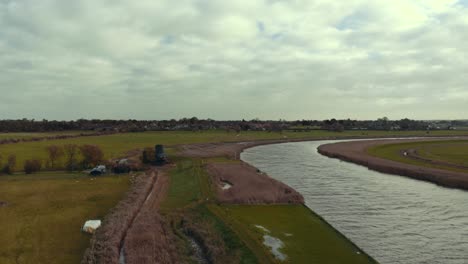 Aerial-drone-static-shot-of-Norfolk-Broads-canal-waterway-on-overcast-cloudy-day