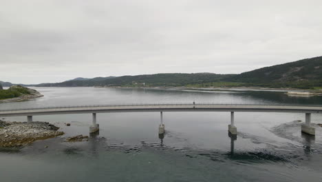 Aerial-flyover-bridge-crossing-Fjord-near-Bodo-City-during-cloudy-day-in-Norway