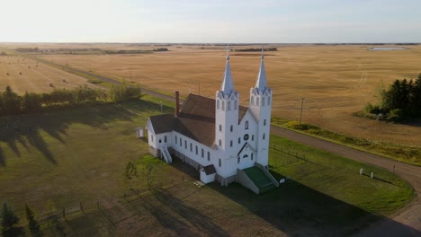 Aerial-footage-of-St-Peters-roman-catholic-church-in-prairie-during-sunset