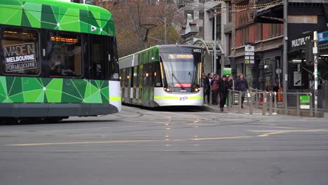 Video-footage-of-Melbourne-Australia-Iconic-Southern-Cross-Station-Junction-traffics-view-with-trams,-cars-and-pedestrians---a-corner-view-showcasing-Melbourne-lifestyle