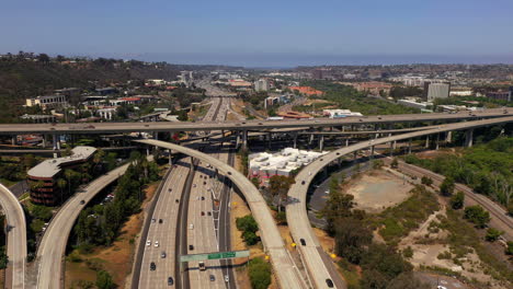 Busy-multi-lane-freeways-and-overpass-in-San-Diego,-aerial-view