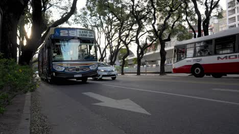 Low-angle-shot-of-traffic-on-road-in-Buenos-Aires,cars-and-buses-driving-on-road-in-Argentina