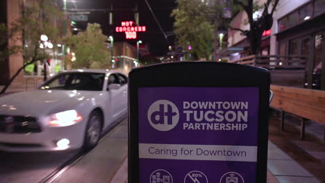 Close-Up-Of-Downtown-Tucson-Partnership---Caring-For-Downtown-Sign-Along-The-Street-In-Tucson,-Arizona-At-Night-During-Pandemic