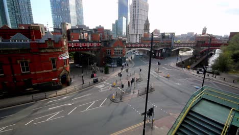 View-from-Manchester-,-Deansgate,-United-Kingdom---25-08-2021:-Manchester-city-centre-Metrolink-trams-at-Deansgate-station,-pedestrian-city-life-transportation-area